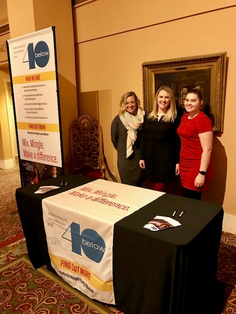 40 Below volunteers stand behind a booth at the Orpheum THeater