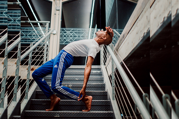 Aaron Derell Gregory dancing in a stairwell