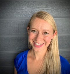 white woman with blonde hair wearing a blue top 