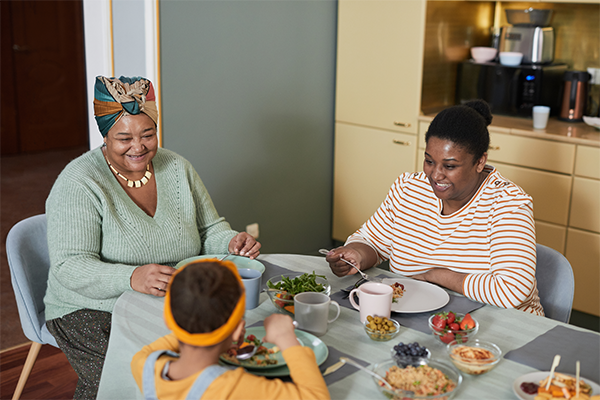 Family eats holiday food around the table.